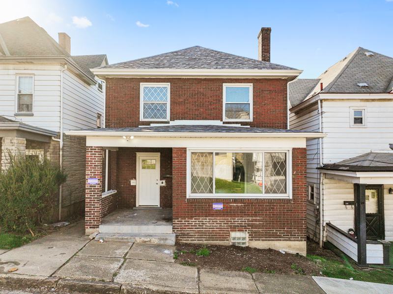 After renovation: renovated brick house with a new front porch, house on 1316 Craig St, McKeesport PA