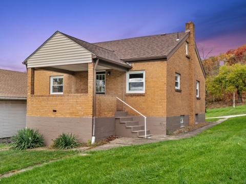 After renovation: front of the house with a new porch and fresh brick, house on 444 27th St, McKeesport PA